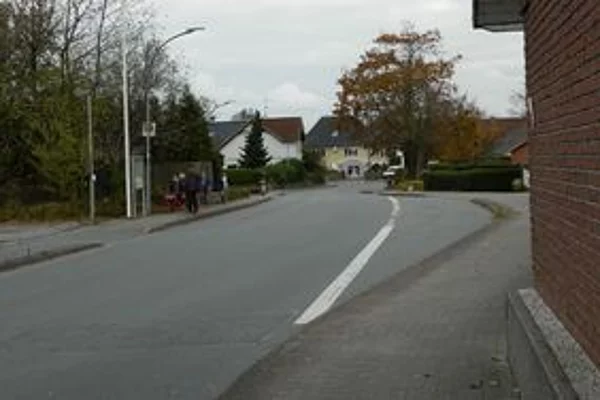 Bild 2 zeigt den gleichen Straßenabschnitt heute. Die Straße ist ausgebaut, mit Busspur, Fuß- und Radweg.